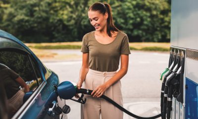 Smiling Woman Refilling Auto with Bio Fuel at Modern Petrol Station Outdoor, Enjoying Refueling Experience. Eco Friendly and Convenient Car Care, Automobile Fueling Offer Concept