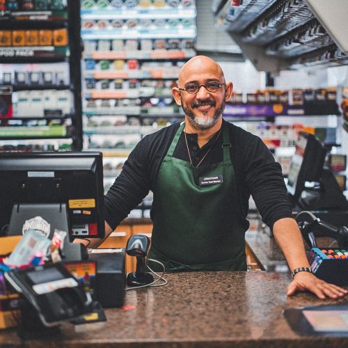 A small business owner at work in his small convenience store.