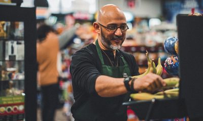 A small business owner at work in his small convenience store.