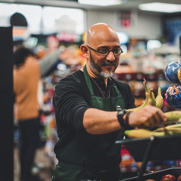 A small business owner at work in his small convenience store.