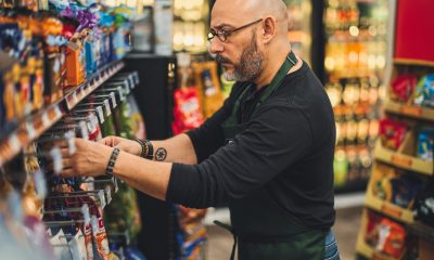 A small business owner at work in his small convenience store.